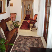 The entrance hall of Hermanus Dorpshuys with persian runners and antique furniture